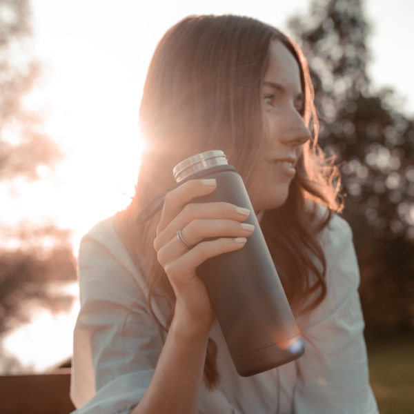 Woman using reusable bottle